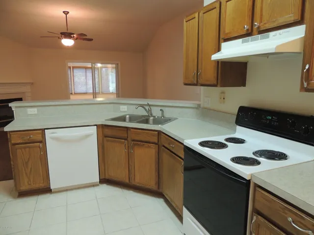 a kitchen with a sink cabinets and appliances