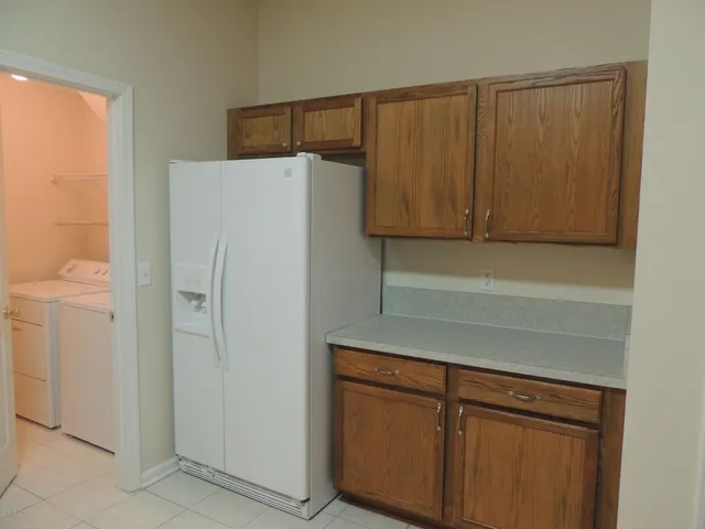 a kitchen with a refrigerator and cabinets