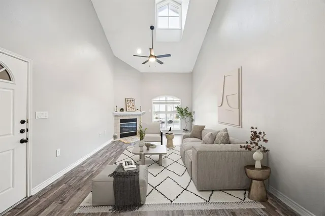 a living room with furniture a chandelier and a window
