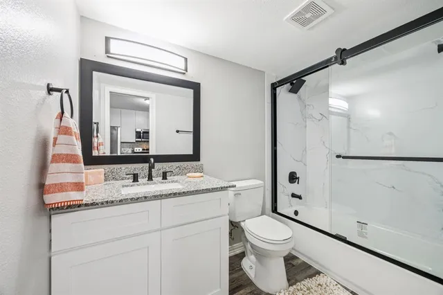 a bathroom with a toilet a sink and a mirror