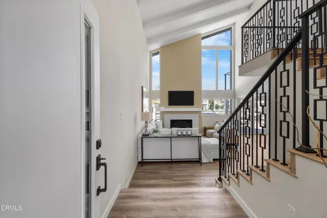 a view of entryway and kitchen with wooden floor