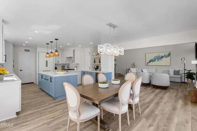 a large kitchen with a table and chairs