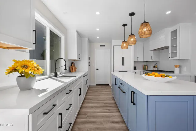 a large kitchen with stainless steel appliances a large center island and a stove