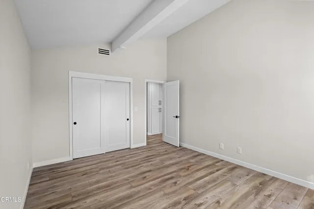 a view of an empty room and wooden floor