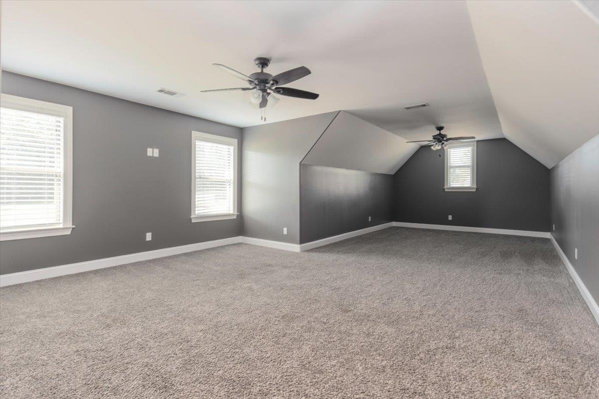 3328 Straw Bridge Road Olive Branch, MS 38654 - Photo 26 of 28 Expansive room featuring plush carpeting, multiple windows with blinds, and two ceiling fans