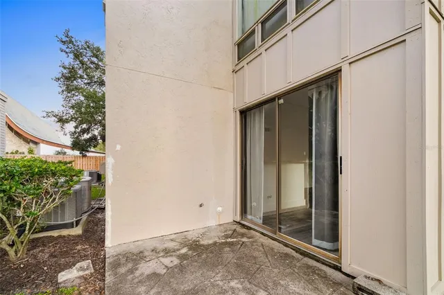 a sign that is sitting in front of a tree