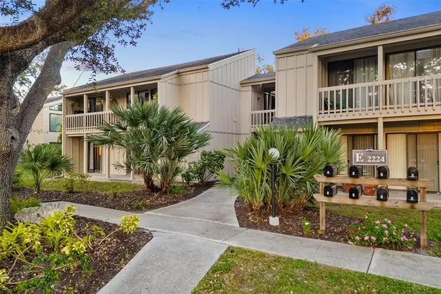 an aerial view of residential house with swimming pool and lawn chairs