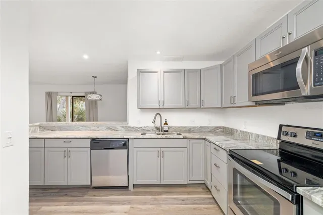 a kitchen with a sink stove and cabinets