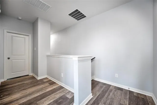 a view of room with wooden floor