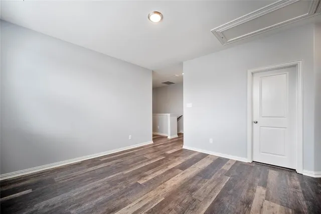 a view of an empty room and wooden floor