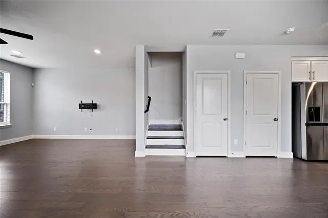 an empty room with a door and wooden floor