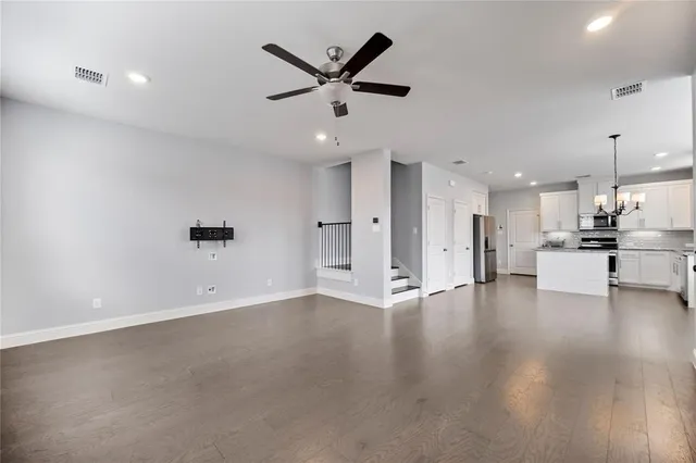 a view of an empty room with a kitchen