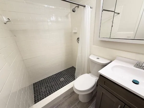 a bathroom with a sink toilet and shower