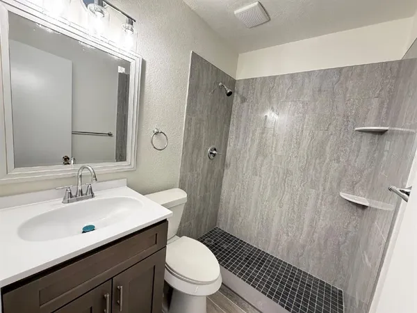 a bathroom with a sink toilet and shower