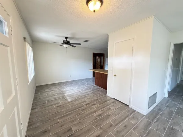 a view of a kitchen with a sink and refrigerator