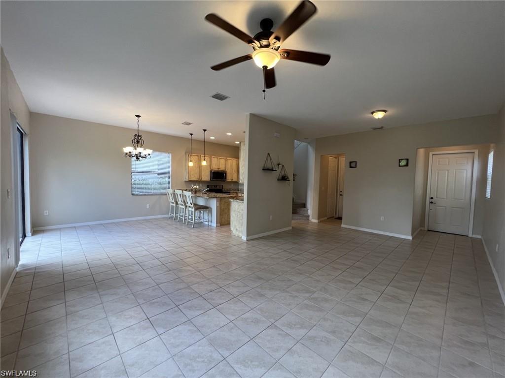5459 Useppa Drive Ave Maria, FL 34142 - Photo 26 of 27 a view of a livingroom with a ceiling fan and kitchen view
