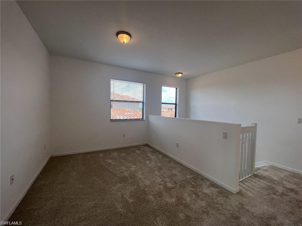 5459 Useppa Drive Ave Maria, FL 34142 - Photo 4 of 27 an empty room with windows