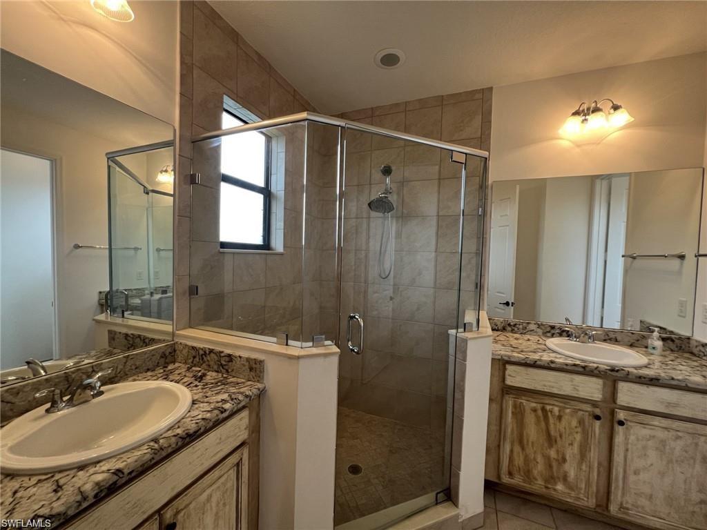 5459 Useppa Drive Ave Maria, FL 34142 - Photo 7 of 27 a bathroom with a shower sink vanity granite and mirror