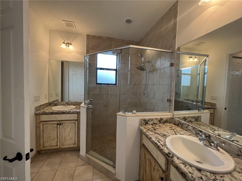 5459 Useppa Drive Ave Maria, FL 34142 - Photo 8 of 27 a bathroom with a sink and a mirror