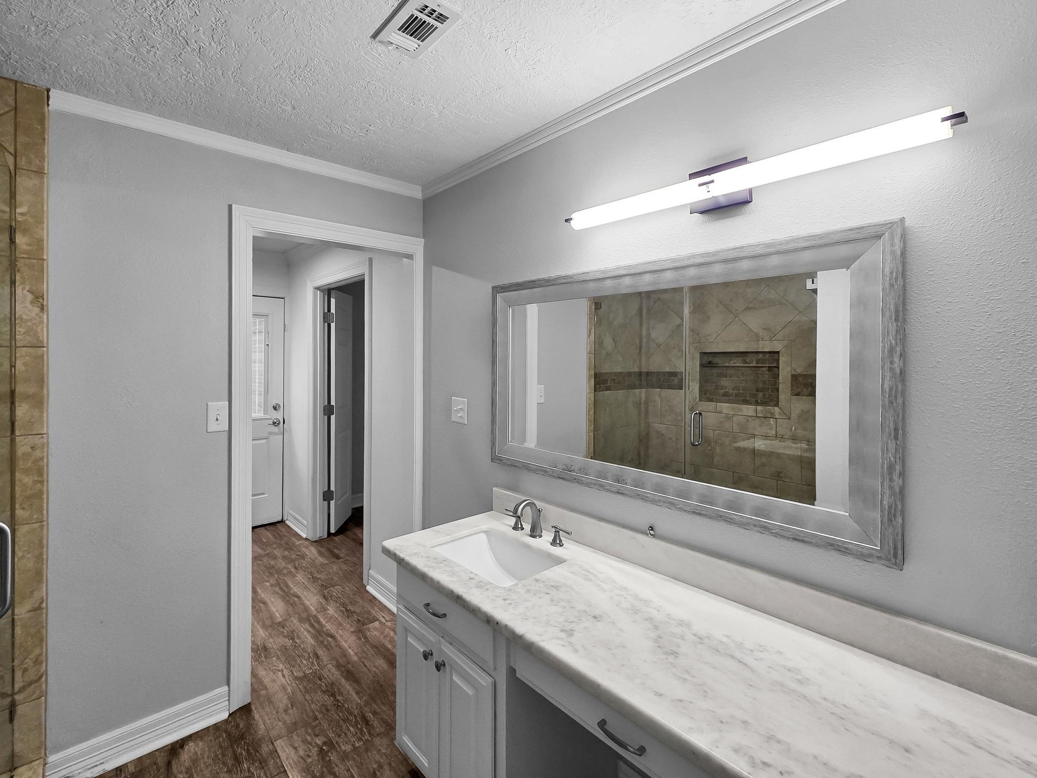 2641 Oilla Road Orange, TX 77630 - Photo 26 of 50 a bathroom with a granite countertop sink mirror and vanity