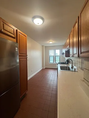 a view of a kitchen with a sink and dishwasher refrigerator stove
