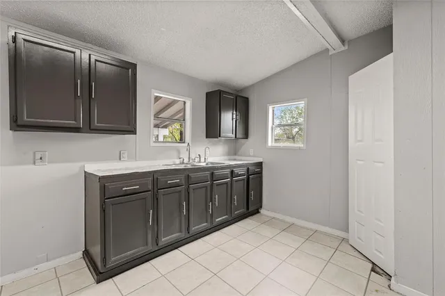 a spacious bathroom with a sink and a mirror