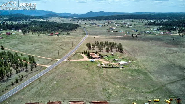 an aerial view of a house with outdoor space and street view