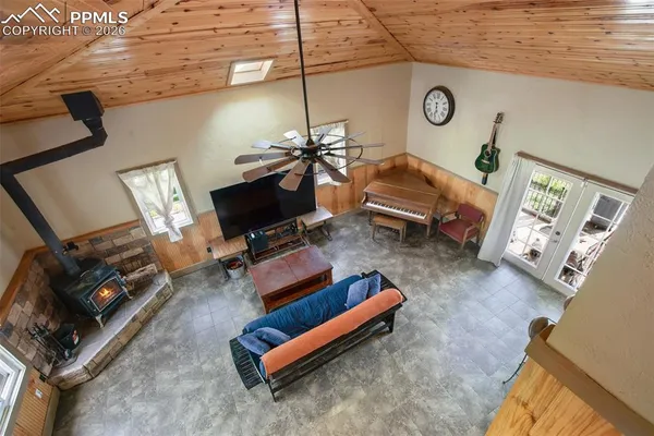 a living room with furniture a flat screen tv and gym equipment