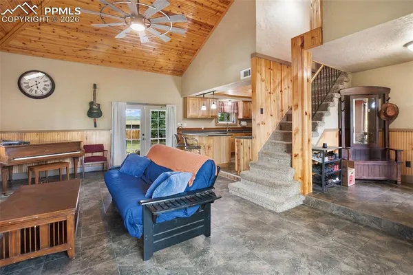 a living room with furniture a dining table and a stove top oven
