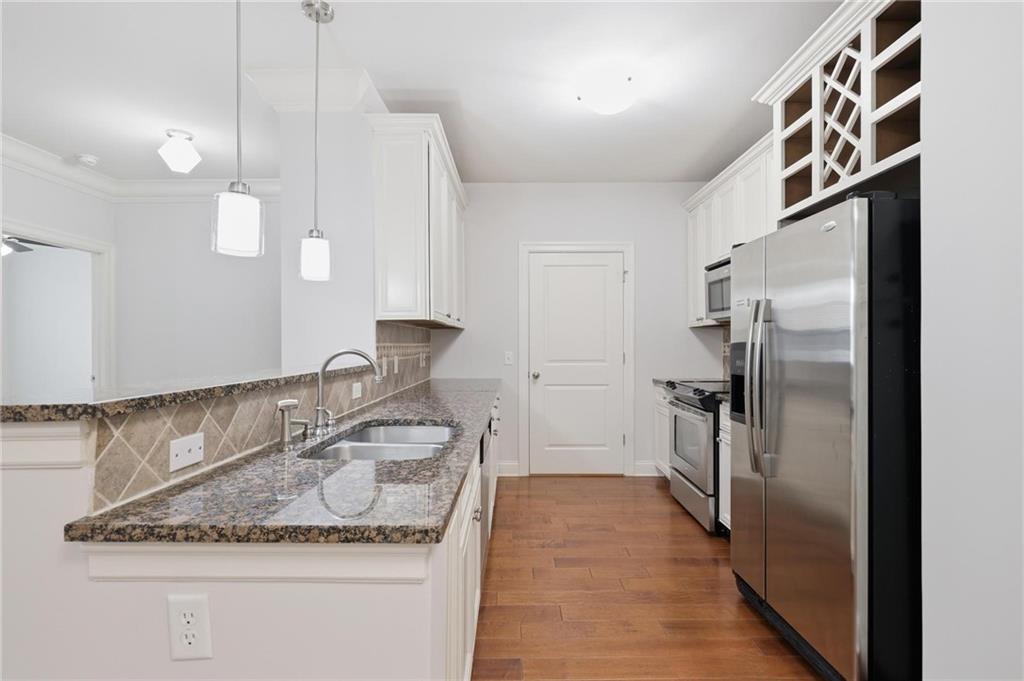 901 Abernathy Road Northeast, Unit 3080 Atlanta, GA 30328 - Photo 7 of 21 a kitchen with stainless steel appliances granite countertop a sink stove and refrigerator