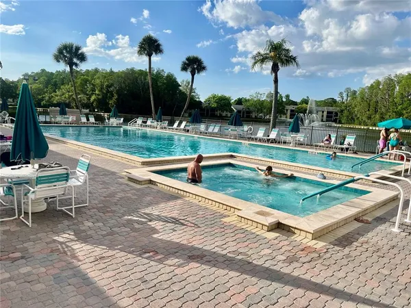 a view of swimming pool with a lounge chairs