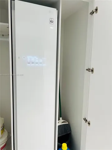 a kitchen with refrigerator and table