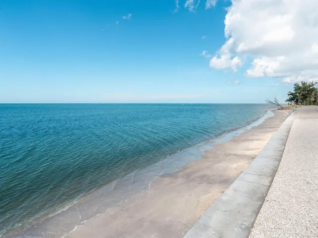 a living room with furniture and floor to ceiling windows