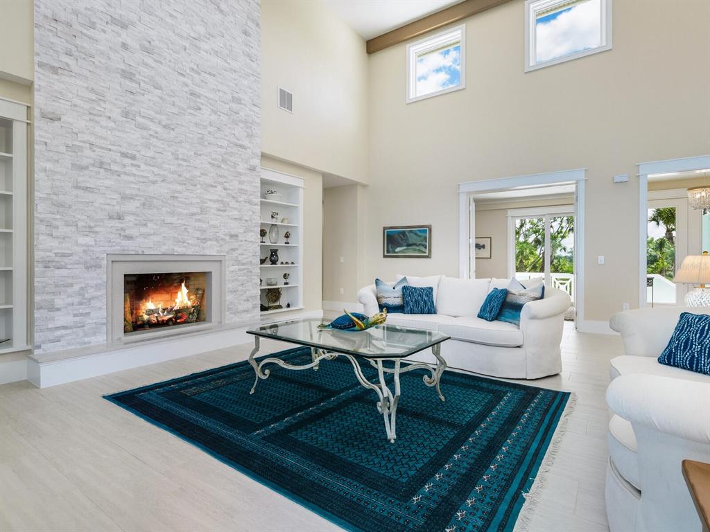 790 North Manasota Key Road Englewood, FL 34223 - Photo 20 of 80 a living room with furniture a coffee table and a fireplace