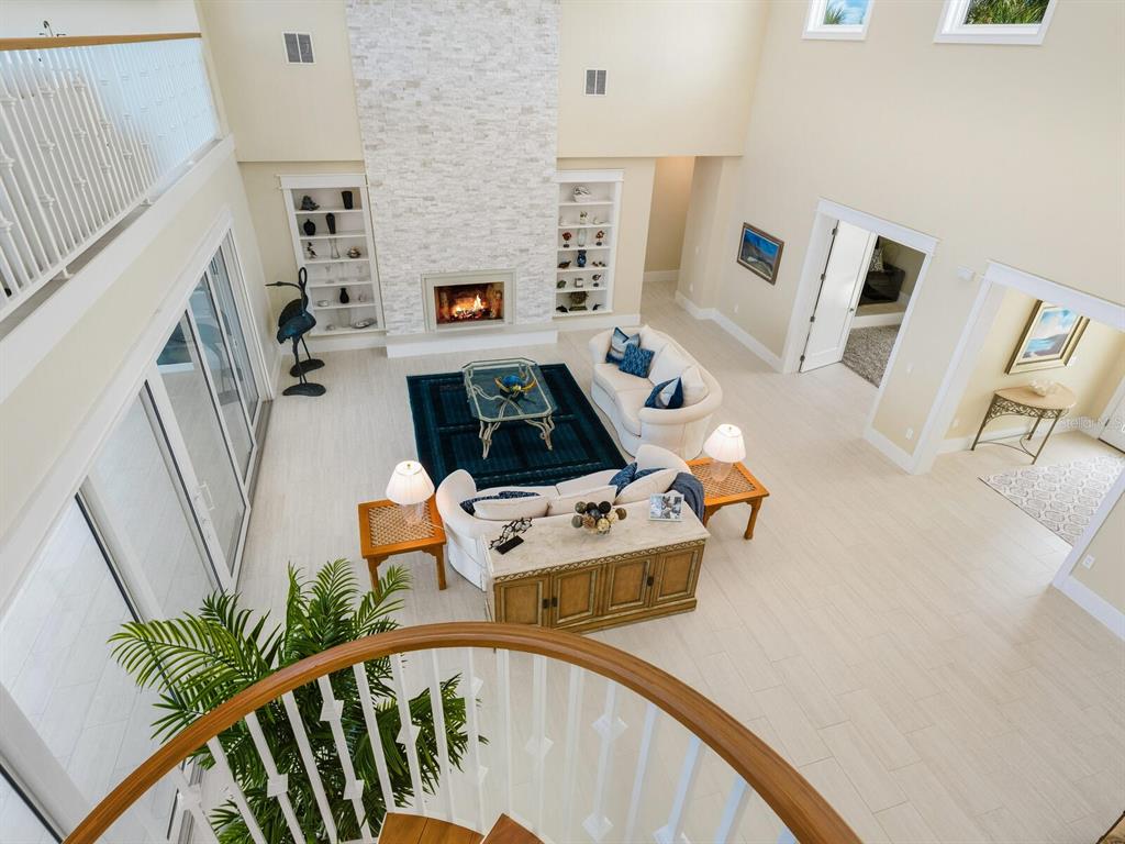 790 North Manasota Key Road Englewood, FL 34223 - Photo 25 of 80 a living room with furniture and floor to ceiling windows