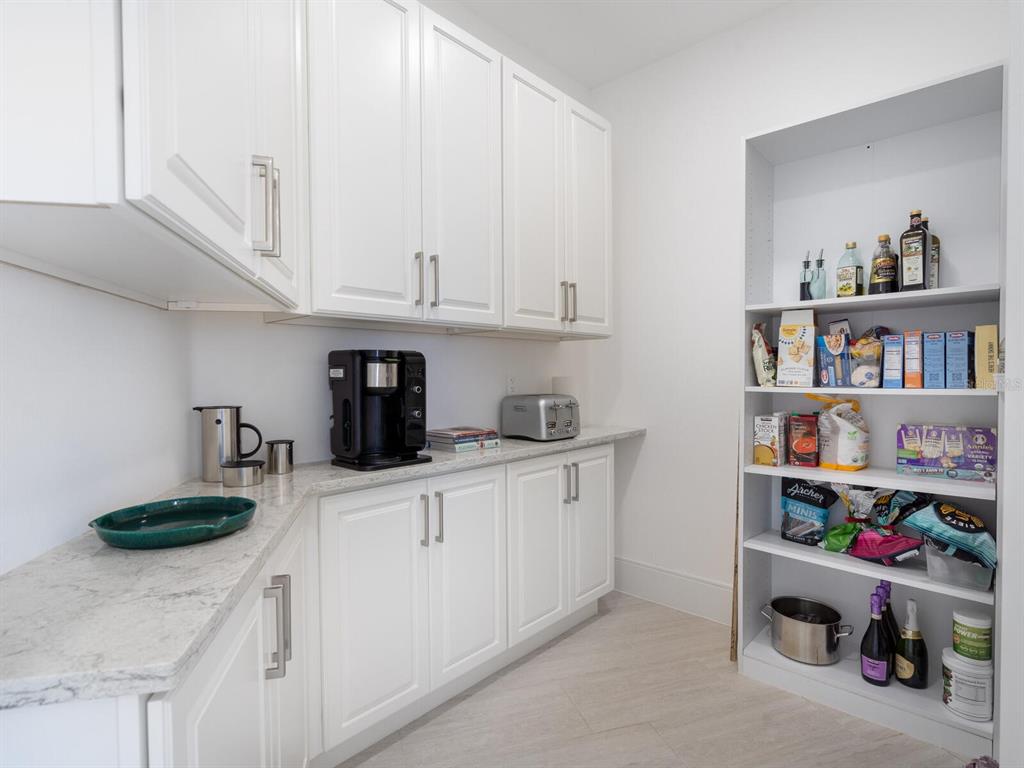 790 North Manasota Key Road Englewood, FL 34223 - Photo 34 of 80 a kitchen with stainless steel appliances granite countertop a sink a stove and cabinets