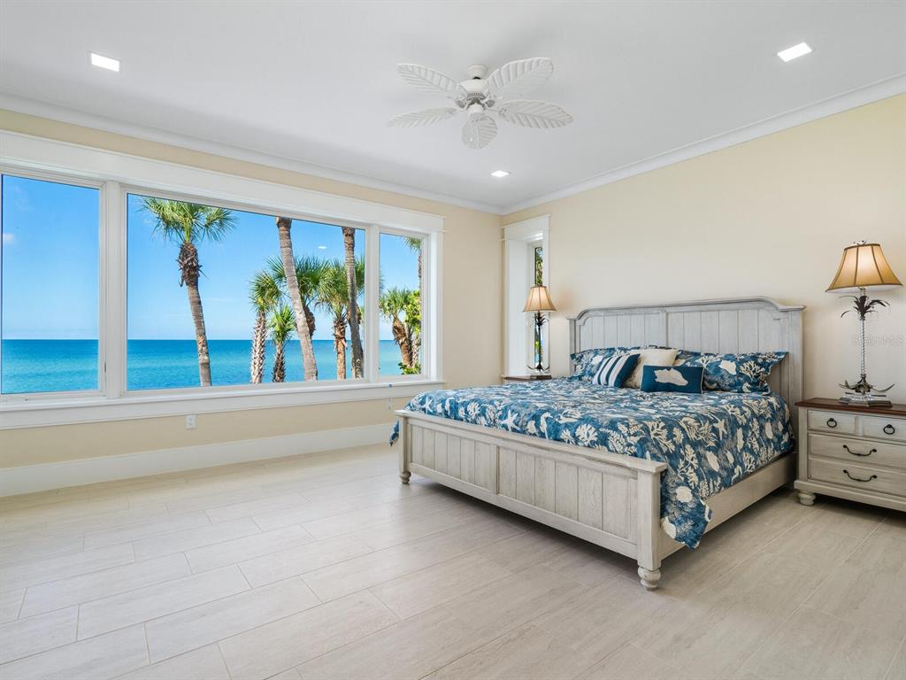 790 North Manasota Key Road Englewood, FL 34223 - Photo 35 of 80 a bed sitting in a spacious bedroom next to a window