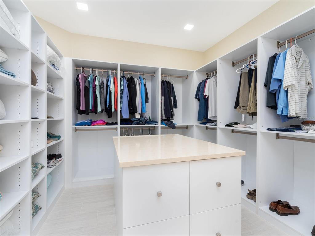 790 North Manasota Key Road Englewood, FL 34223 - Photo 39 of 80 a view of walk in closet with clothes and shoes