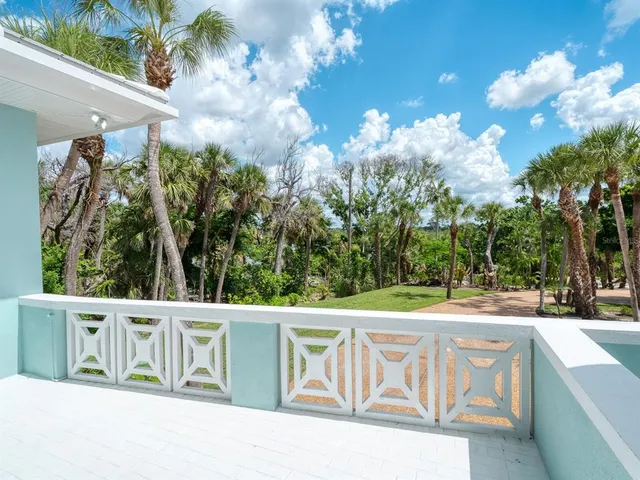 a front view of a house with a garden and yard