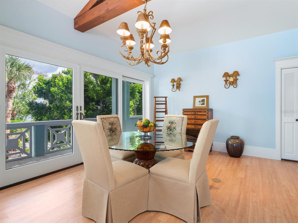 790 North Manasota Key Road Englewood, FL 34223 - Photo 54 of 80 a view of a dining room with furniture a chandelier and wooden floor