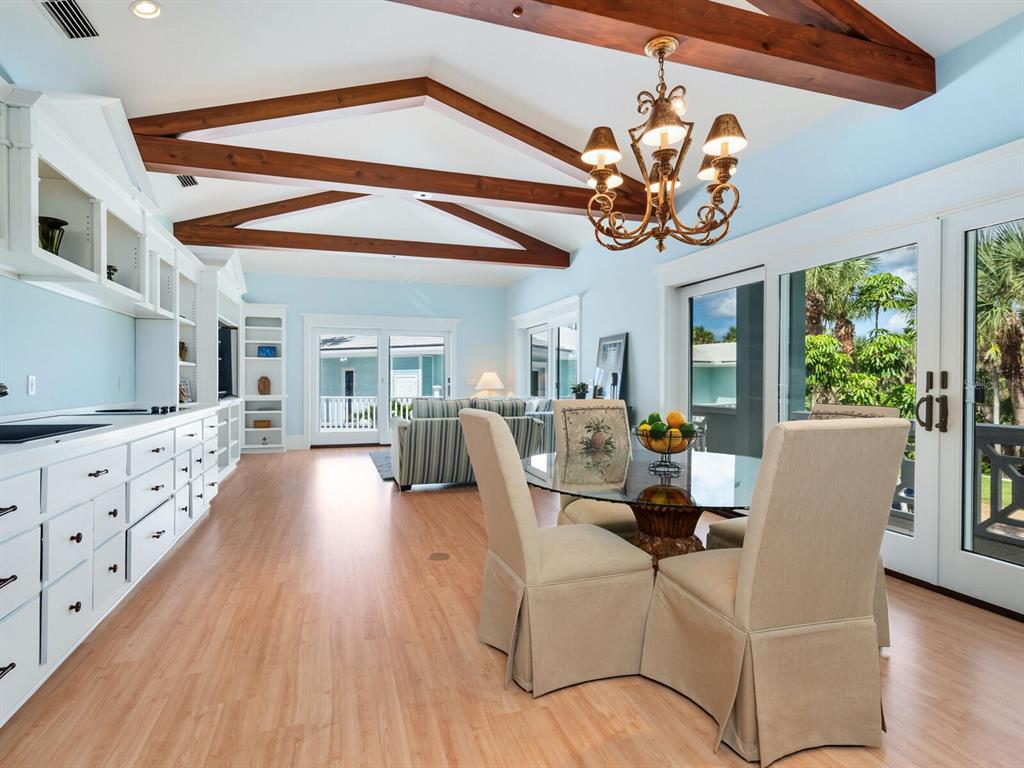790 North Manasota Key Road Englewood, FL 34223 - Photo 56 of 80 a view of a dining room with furniture a chandelier and wooden floor
