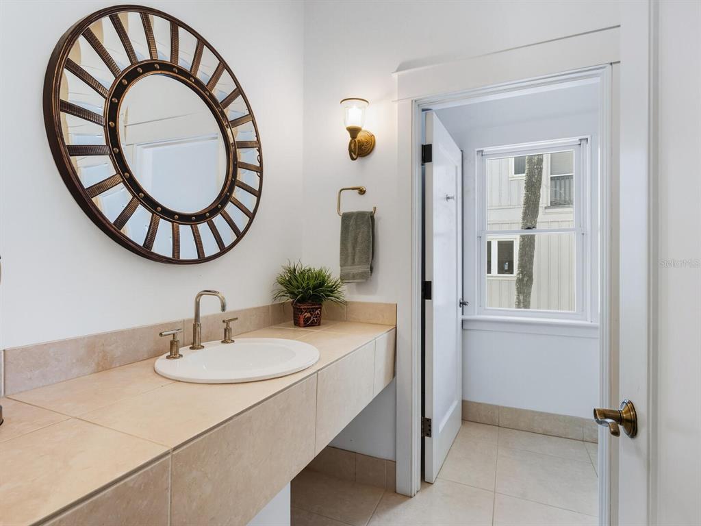 790 North Manasota Key Road Englewood, FL 34223 - Photo 58 of 80 a bathroom with a sink and a mirror