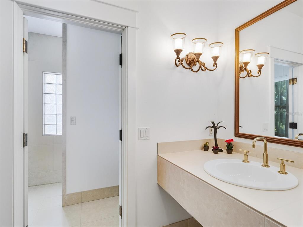 790 North Manasota Key Road Englewood, FL 34223 - Photo 60 of 80 a bathroom with a sink and a mirror