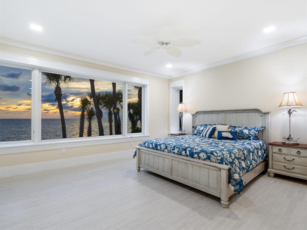 790 North Manasota Key Road Englewood, FL 34223 - Photo 71 of 80 a spacious bedroom with a bed and large window
