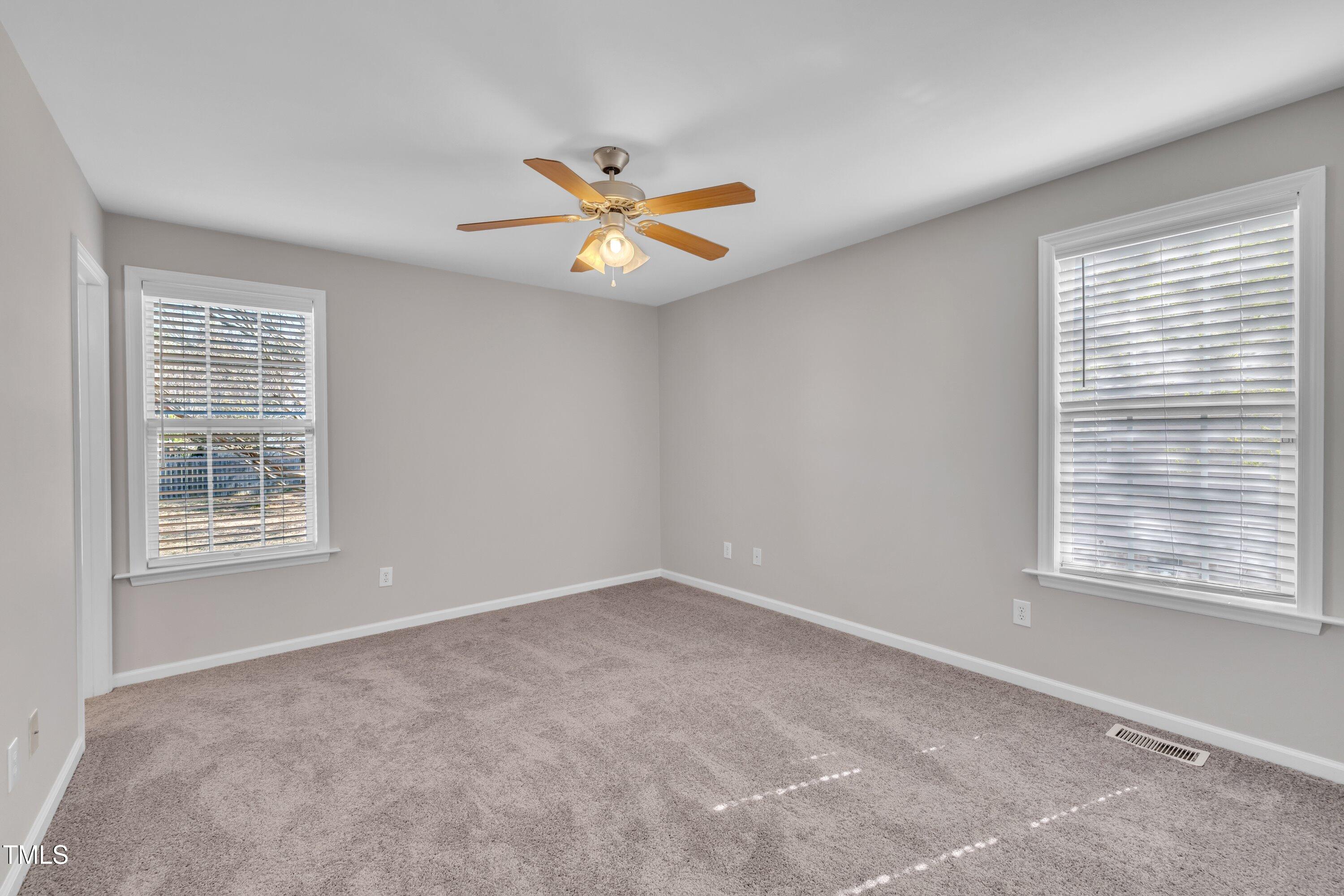 147 Tralee Drive Smithfield, NC 27577 - Photo 11 of 43 an empty room with a window and a fan