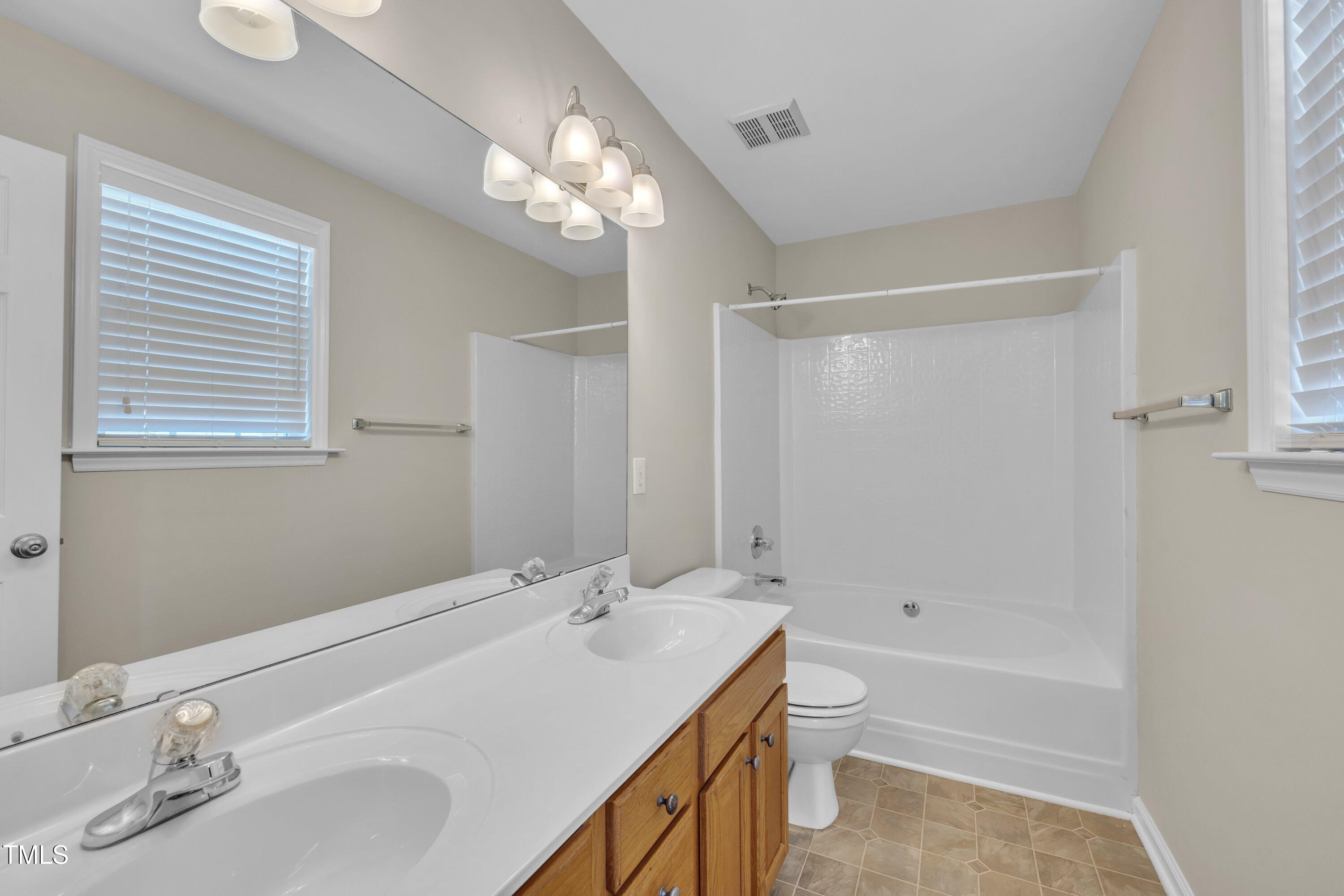 147 Tralee Drive Smithfield, NC 27577 - Photo 15 of 43 a bathroom with a sink a toilet and shower