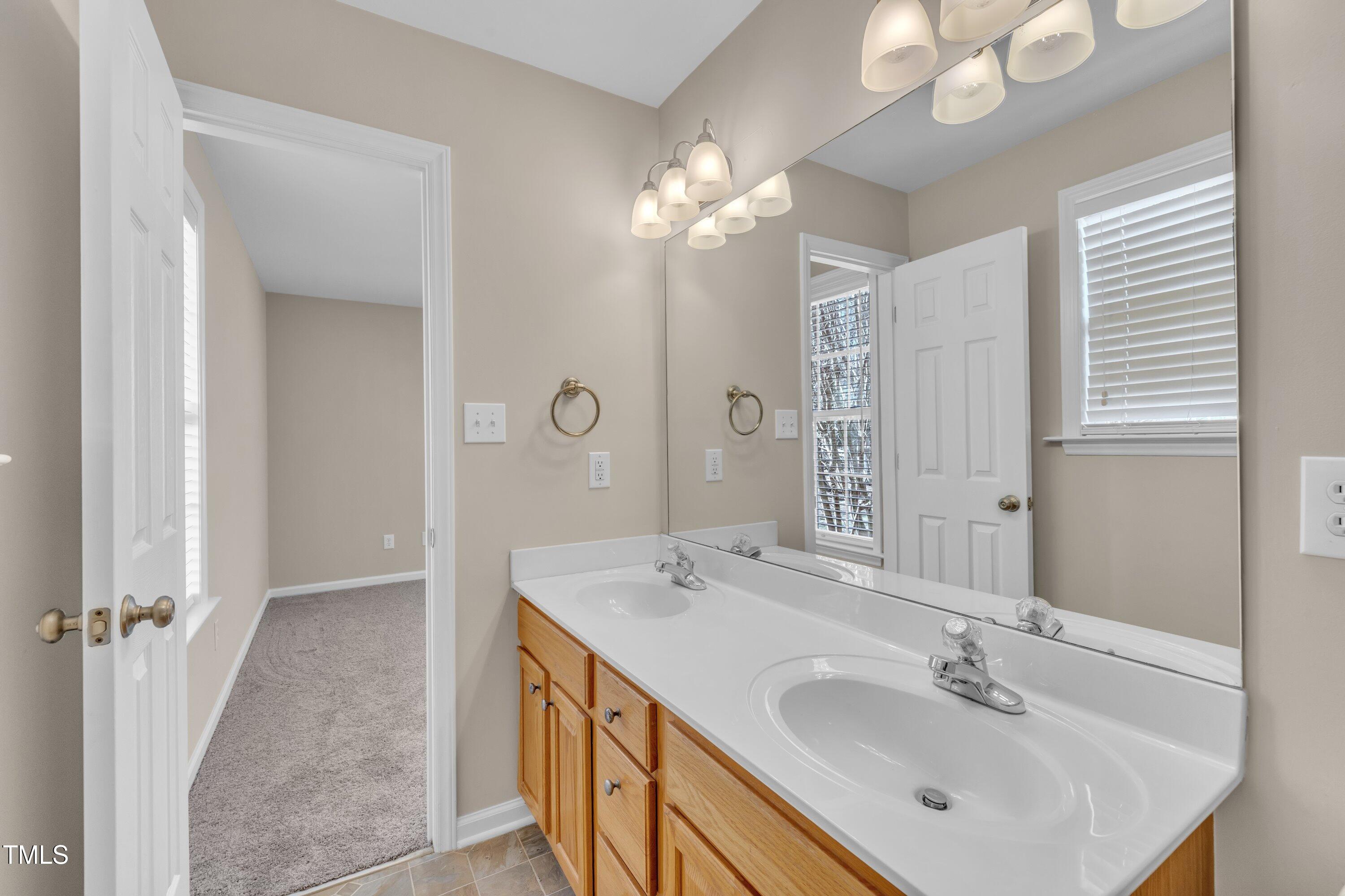 147 Tralee Drive Smithfield, NC 27577 - Photo 16 of 43 a bathroom with a sink a light fixture and a mirror