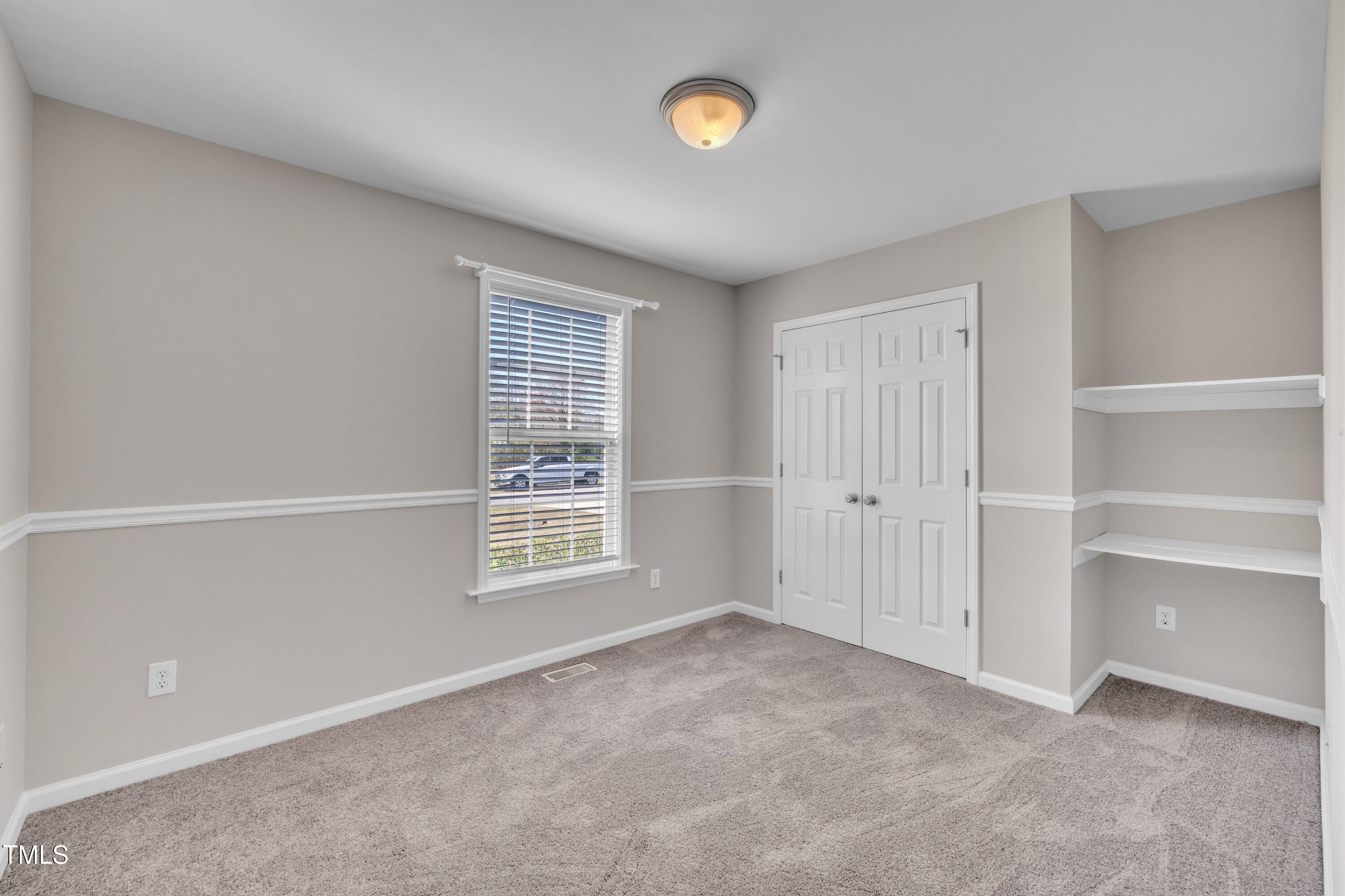 147 Tralee Drive Smithfield, NC 27577 - Photo 19 of 43 a view of an empty room with a window