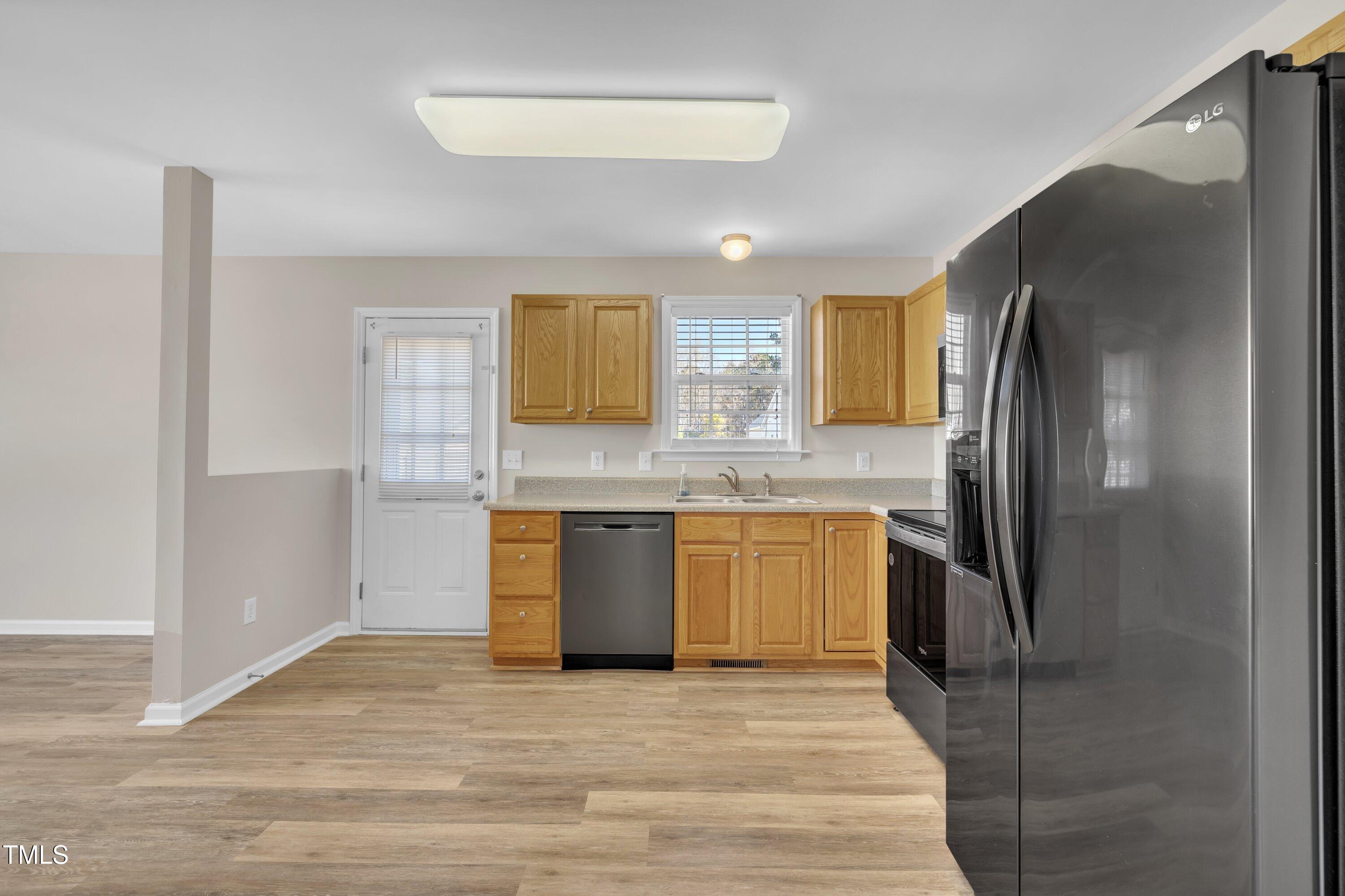 147 Tralee Drive Smithfield, NC 27577 - Photo 25 of 43 a kitchen with stainless steel appliances granite countertop a refrigerator and a sink