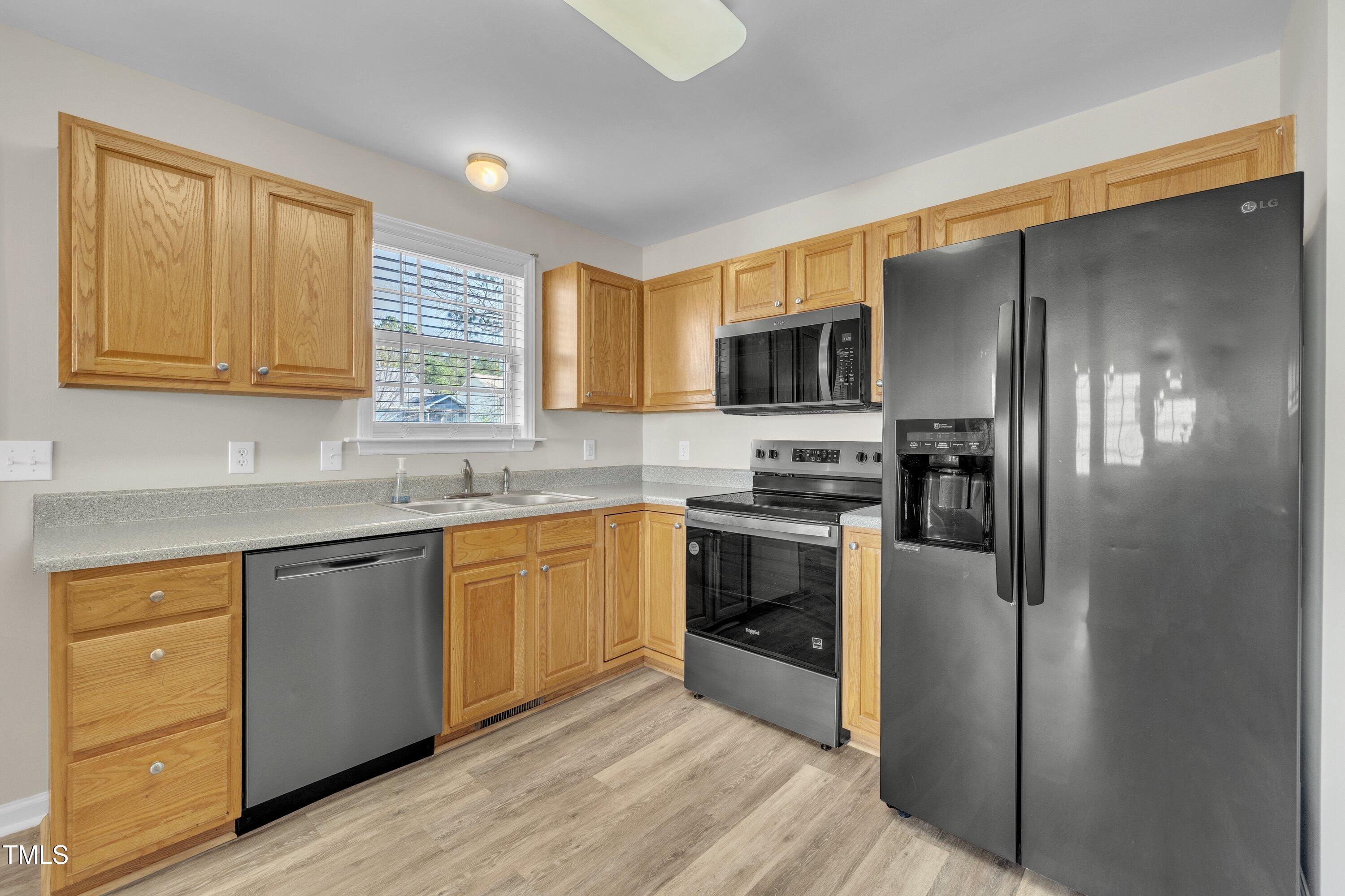 147 Tralee Drive Smithfield, NC 27577 - Photo 26 of 43 a kitchen with granite countertop a refrigerator stove and microwave